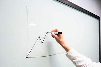 Hand drawing growth graph on whiteboard