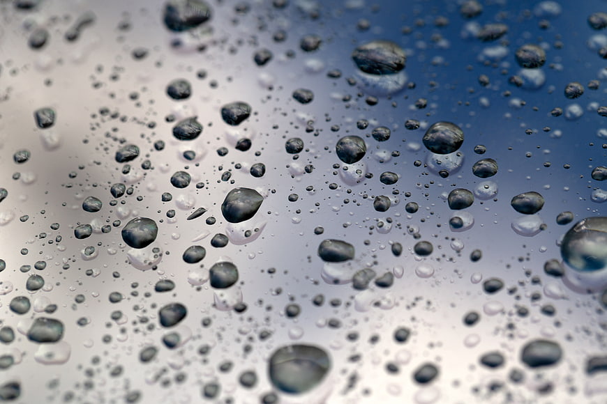 Macro Water Droplets on Glass with Blue Gradient Background