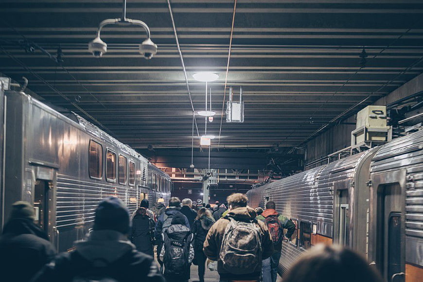 Crowded Commuters Walking Between Trains at Night