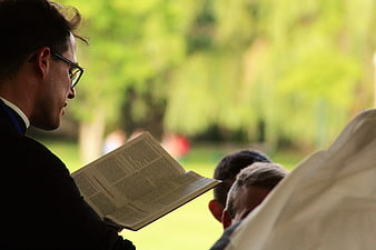 Man Reading Bible Outdoors in Profile