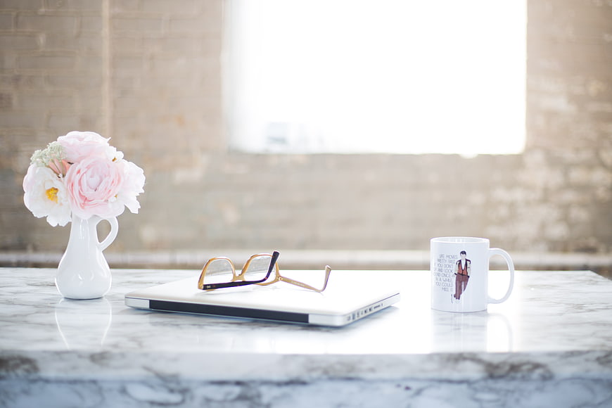 Pink Flowers, Laptop, and Coffee Mug on Marble Desk