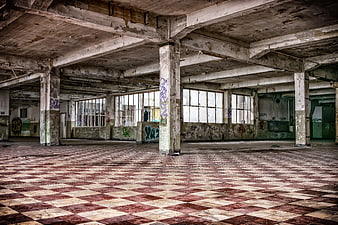 Abandoned Factory Interior with Checkered Floor and Graffiti
