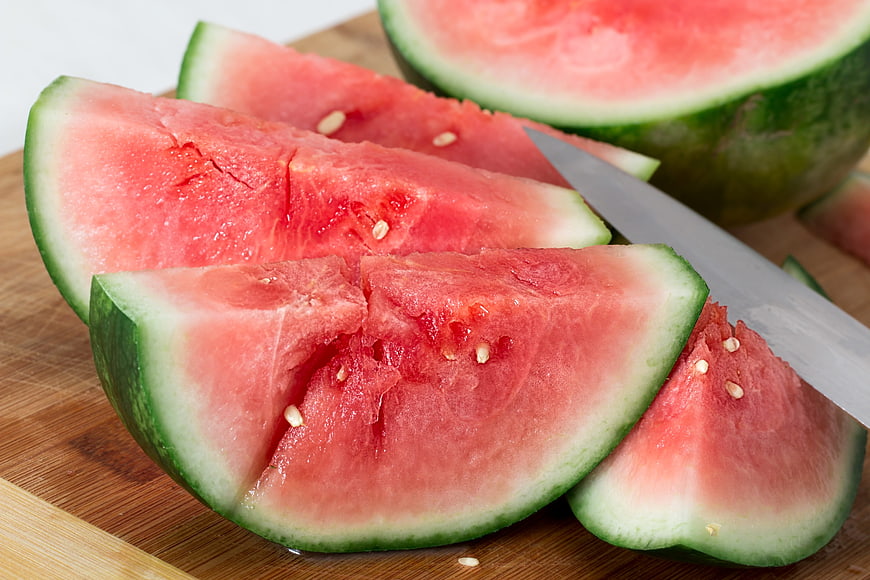 Fresh Sliced Watermelon on Wooden Cutting Board with Knife