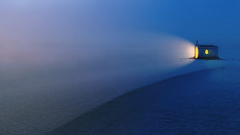 Illuminated Chapel In Snowy Foggy Winter Landscape At Dusk