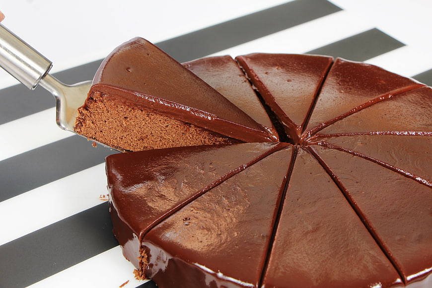 Slice of chocolate cake on a striped background