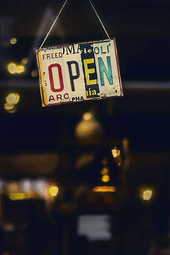 Vintage Open Sign Hanging in Window at Night