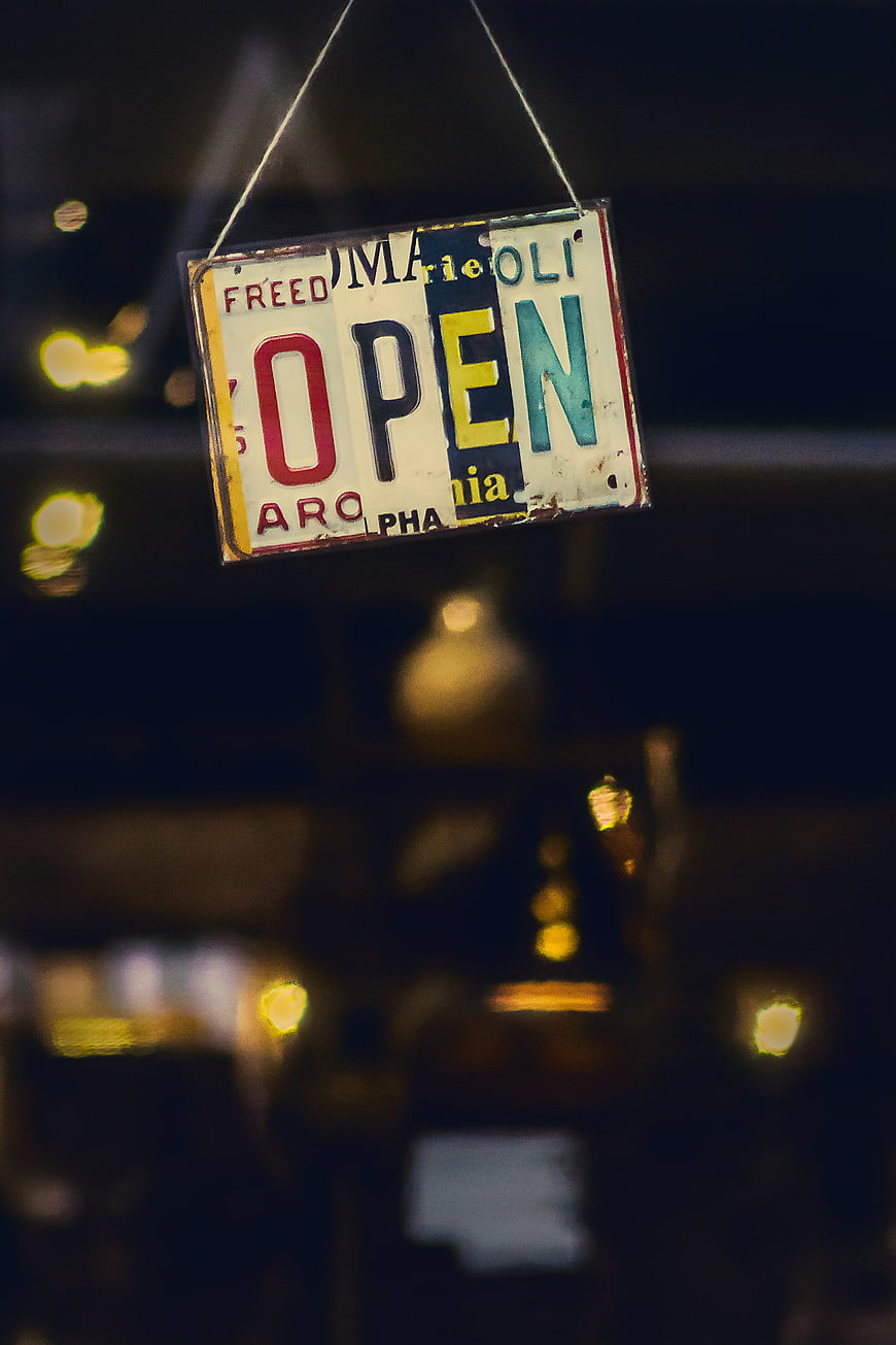 Vintage Open Sign Hanging in Window at Night