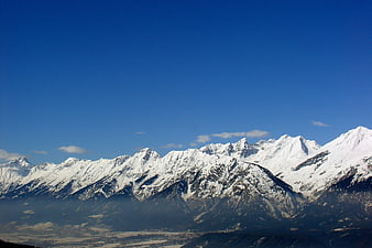 Snow-Capped Mountain Range Under Clear Blue Sky