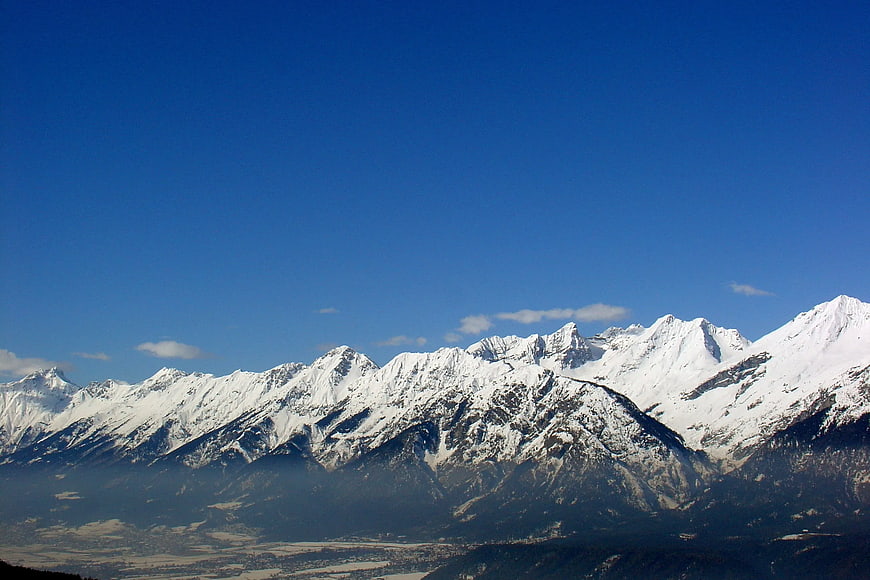 Snow-Capped Mountain Range Under Clear Blue Sky