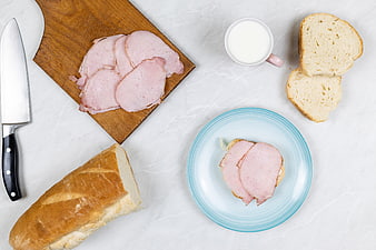 Top view of ham sandwich ingredients on white marble