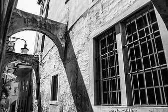 Black and white photo of old European architecture with arches