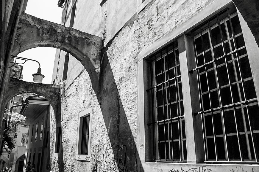 Black and white photo of old European architecture with arches