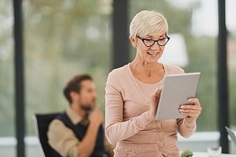 Senior Businesswoman Using Tablet in Modern Office