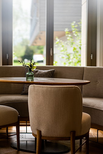 Modern minimalist interior with beige sofa and wooden table