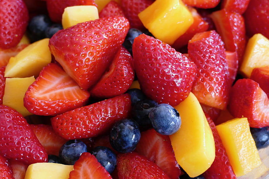 Close-up of fresh strawberry, blueberry, and mango fruit salad
