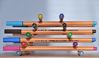 Stacked Multicolored Felt Tip Pens With Orange Barrels