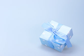 Blue Polka Dot Gift Box with Ribbon on Light Background