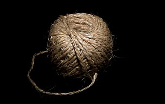 Ball of natural jute twine on black background
