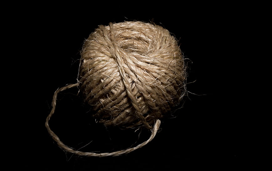 Ball of natural jute twine on black background