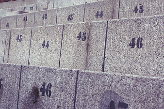 Close-up of numbered concrete stadium seats