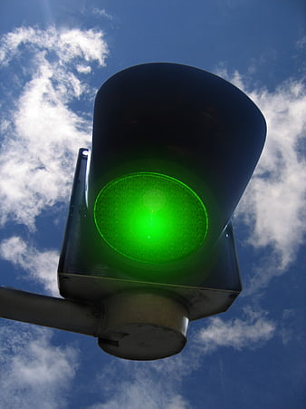 Low Angle Green Traffic Light Signal Against Blue Sky
