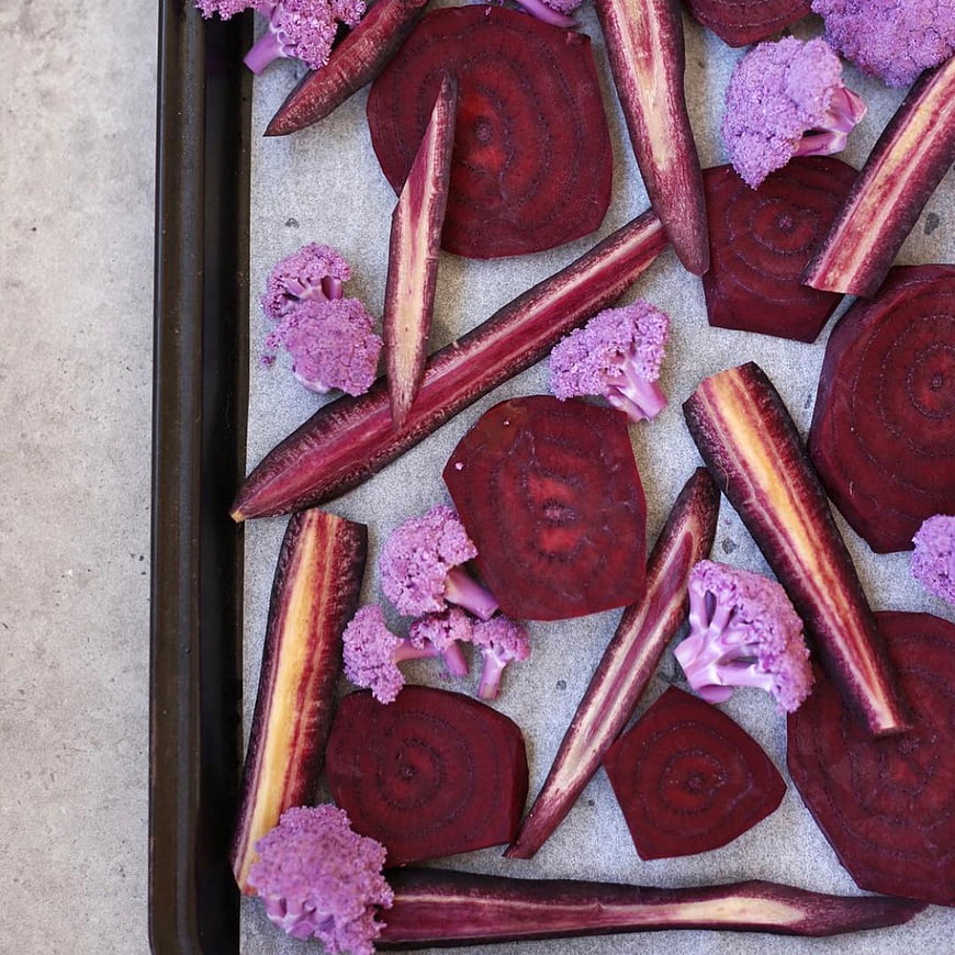 Purple vegetables on baking sheet top view