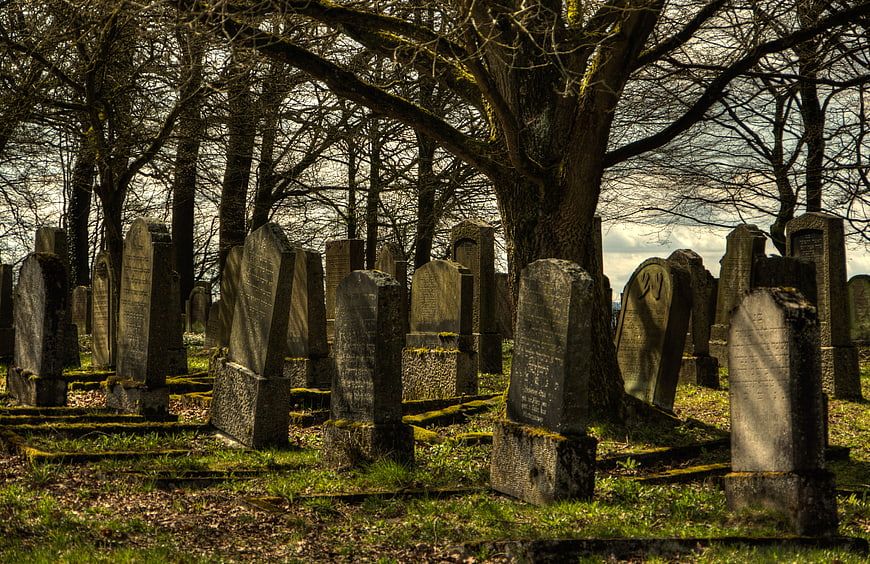 Old Jewish Cemetery with Weathered Tombstones and Trees