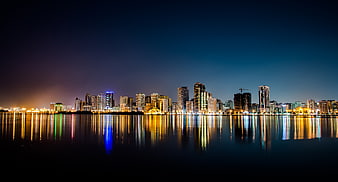 Night Skyline of Modern City Reflected in Calm Water