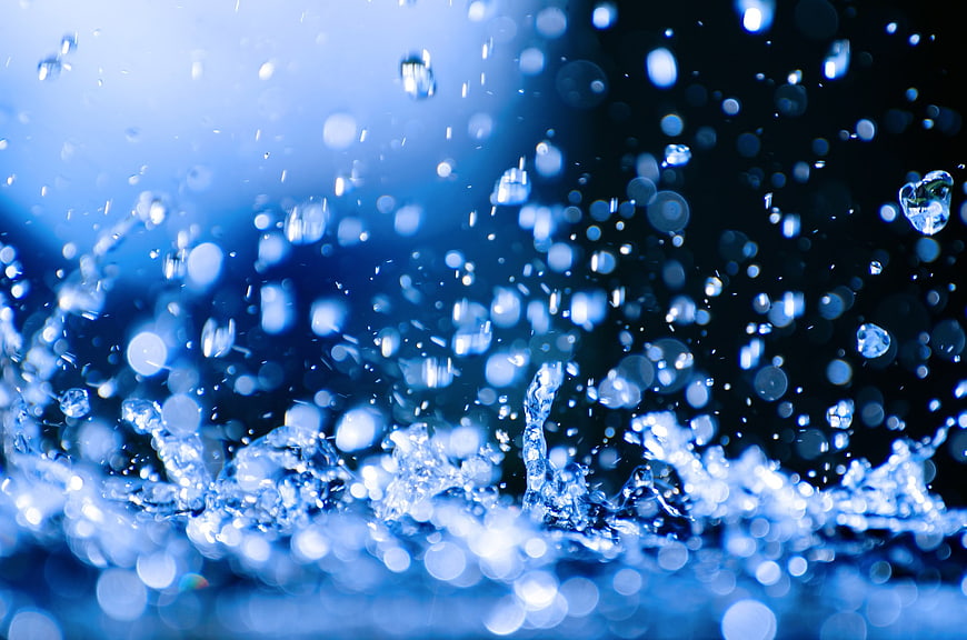 Abstract Blue Water Splash With Bokeh Droplets On Dark Background