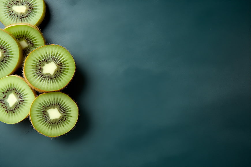 Sliced Kiwi Fruit on Dark Teal Background with Copyspace