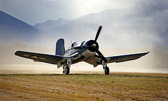 Vintage Corsair Airplane Taking Off on Grassy Runway