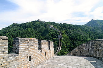 Great Wall of China winding through green mountains