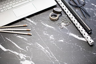 Flat lay of office supplies on gray marble desk