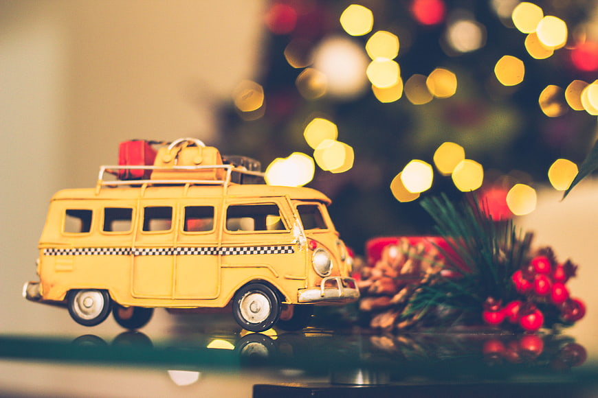 Yellow Toy Van with Christmas Lights and Pine Cones