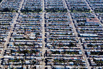 Aerial view of dense urban residential grid with colorful houses