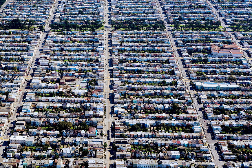 Aerial view of dense urban residential grid with colorful houses
