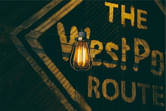 Vintage Edison Bulb Hanging in Front of Westport Route Sign