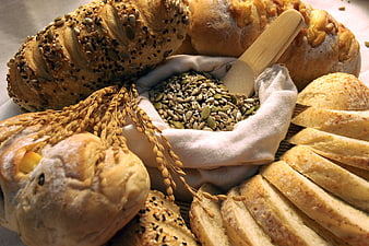 Assorted Artisan Bread Loaves With Seeds And Wheat Stalks