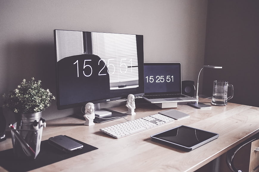 Modern minimalist home office desk setup with dual monitors