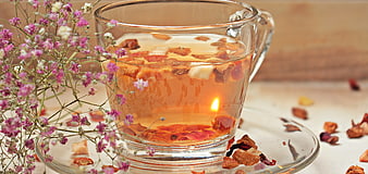 Glass Cup of Herbal Tea with Dried Flowers and Baby's Breath