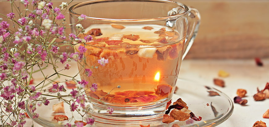 Glass Cup of Herbal Tea with Dried Flowers and Baby's Breath