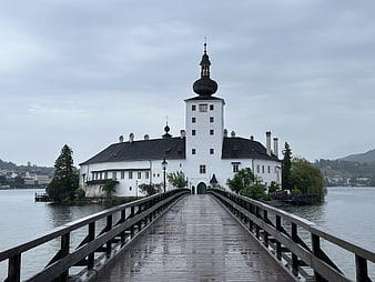 Historic White Castle On Island With Wooden Bridge