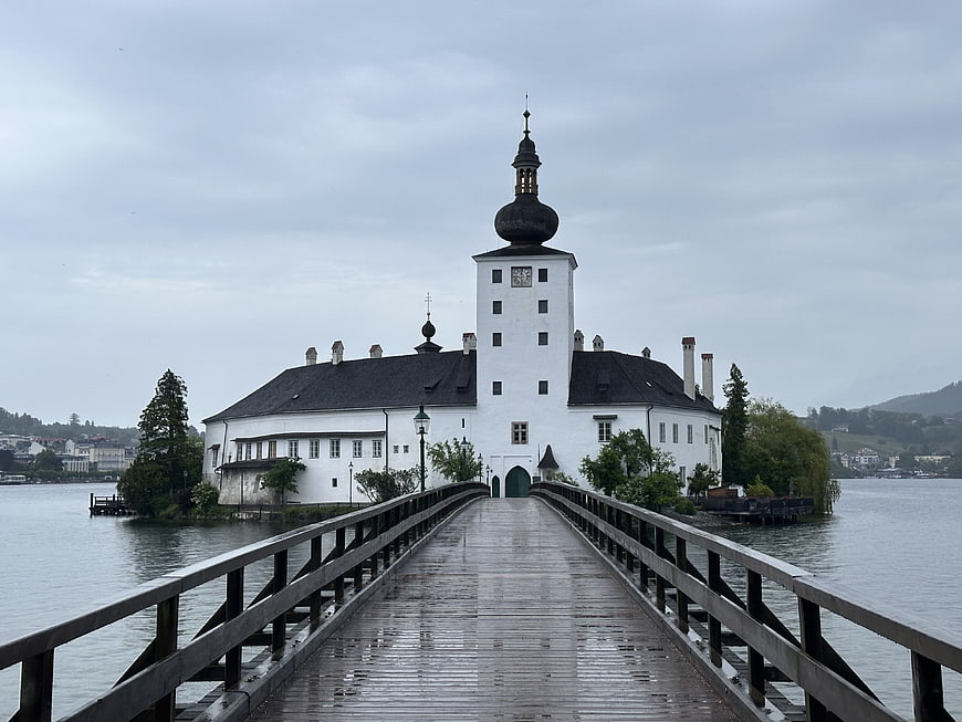 Historic White Castle On Island With Wooden Bridge