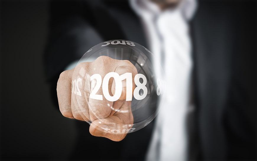 Businessman holding 2018 hologram sphere