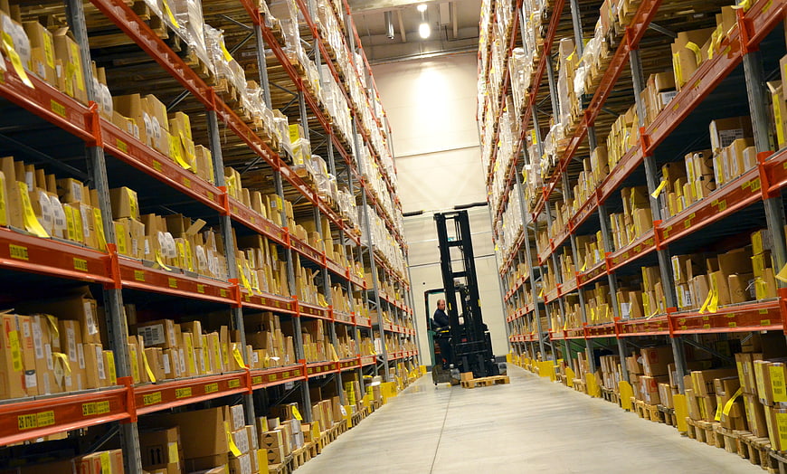 Warehouse Aisle With Forklift And Tall Storage Racks