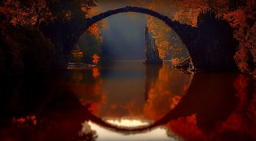 Mystical Autumn Stone Arch Bridge Over Calm River