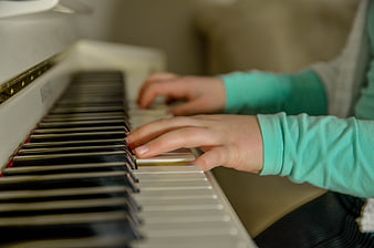 Close-up of hands playing white piano keys