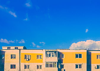 Colorful Apartment Building Against Blue Sky