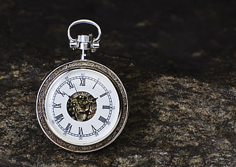 Vintage Silver Pocket Watch With Roman Numerals On Textured Rock