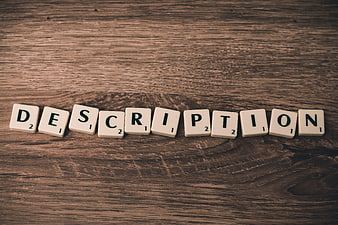 Scrabble Tiles Spelling Description on Wooden Background